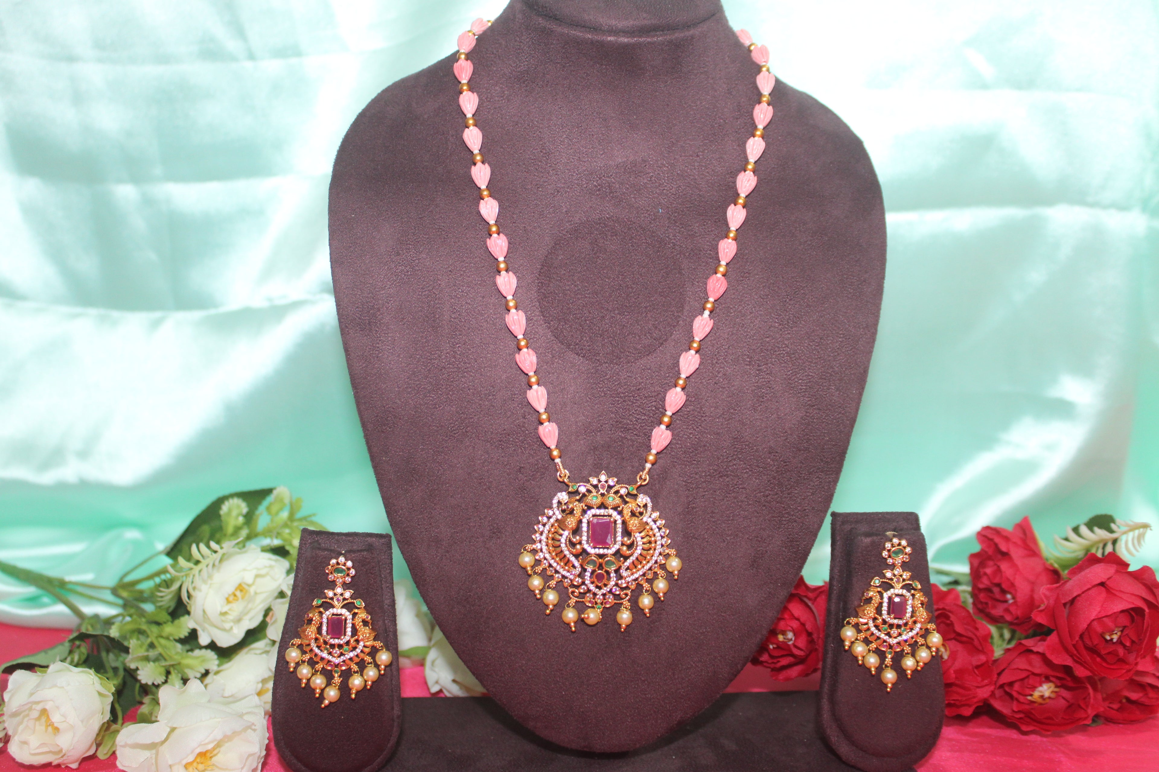 Pink pumpkin beads with maroon stone ,matching earings