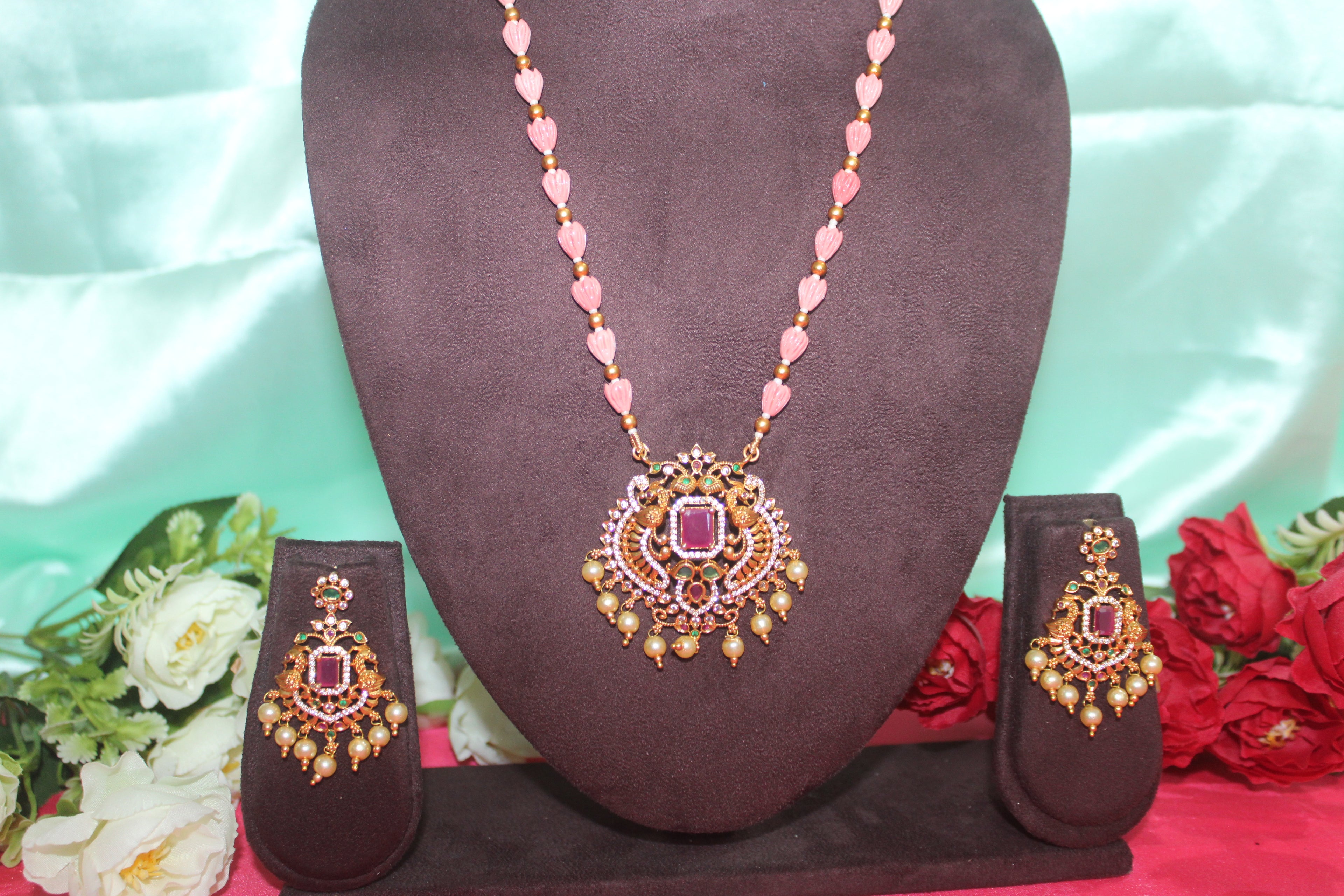 Pink pumpkin beads with maroon stone ,matching earings