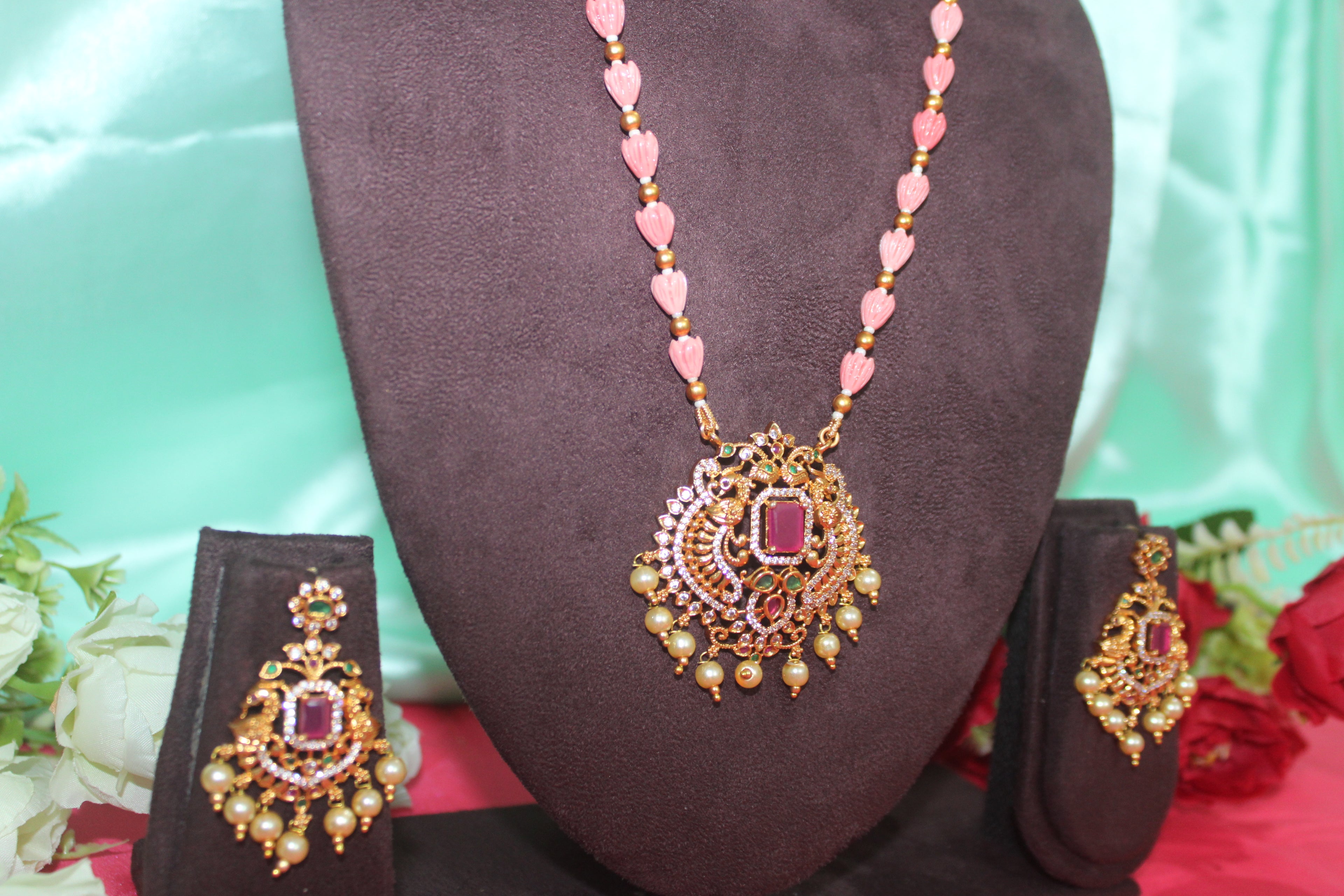 Pink pumpkin beads with maroon stone ,matching earings