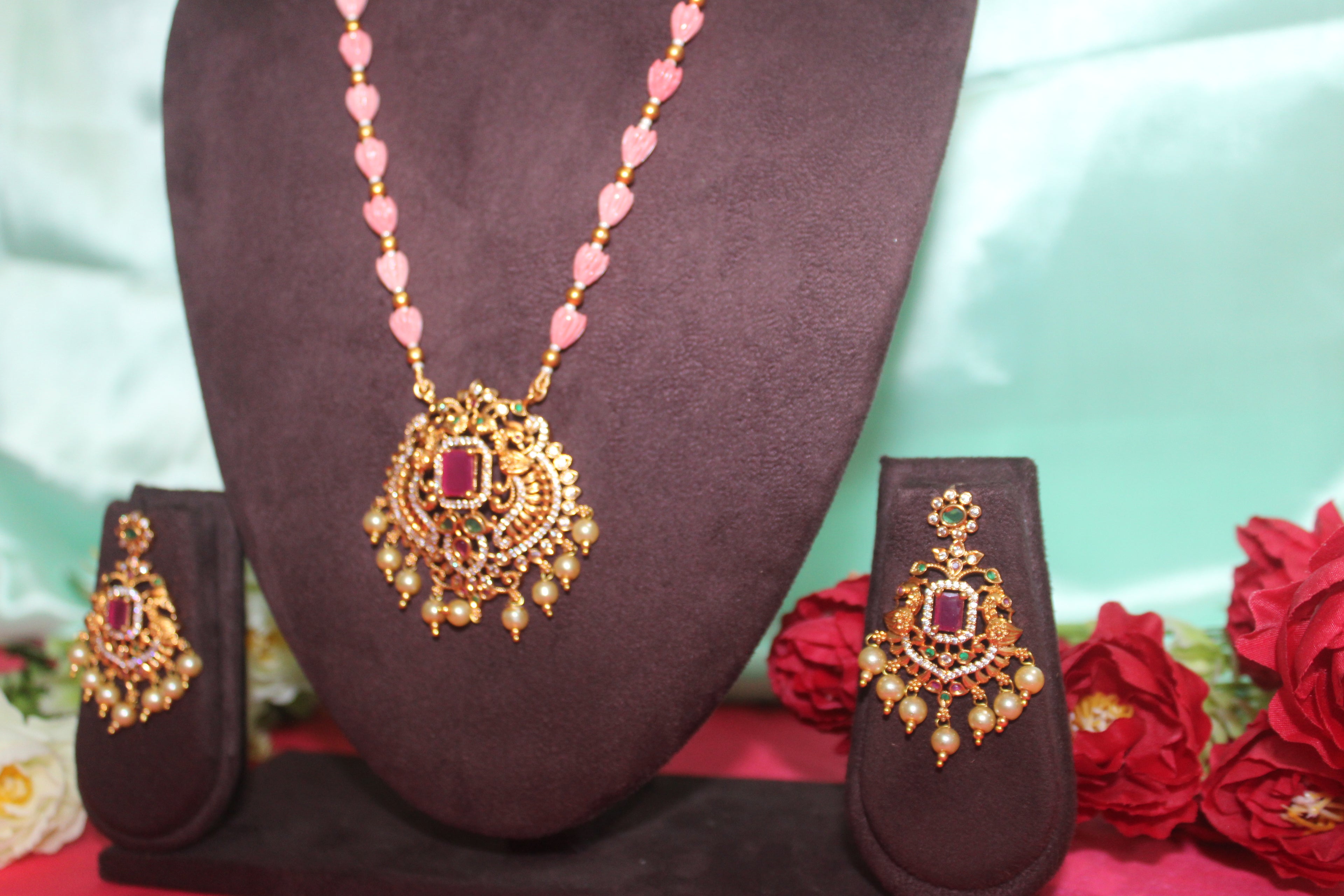 Pink pumpkin beads with maroon stone ,matching earings