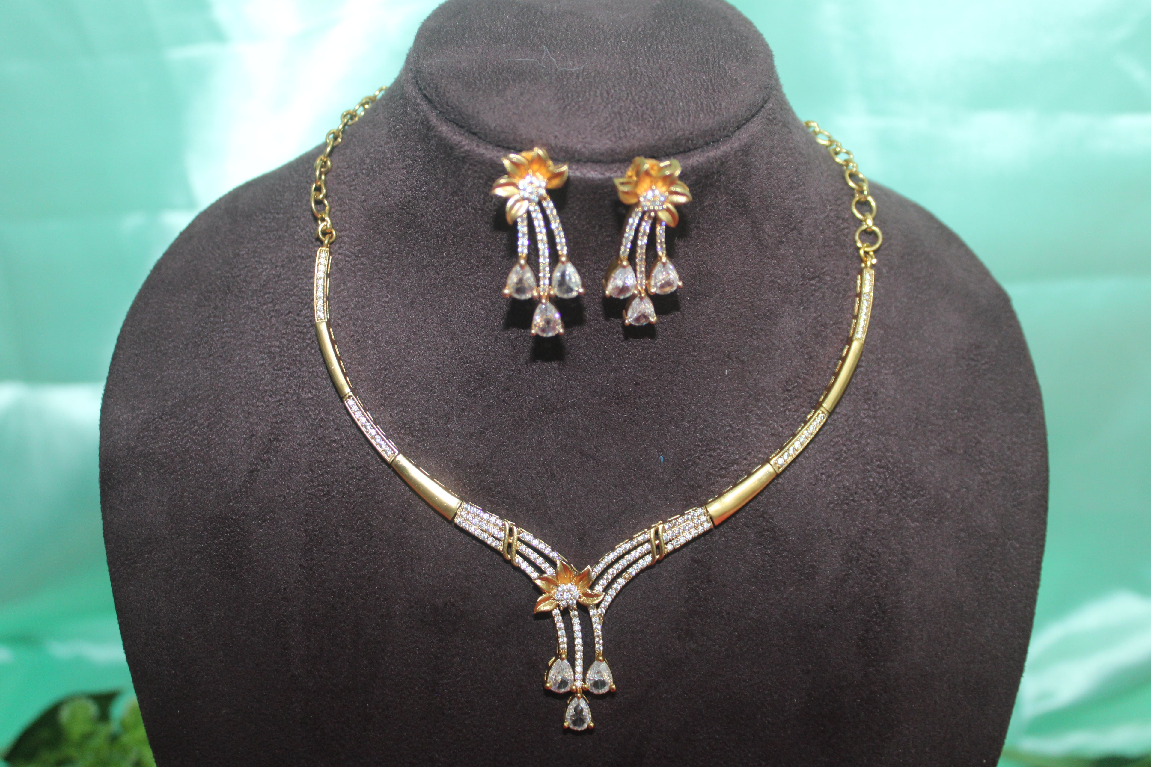 Modern necklace with american diamonds embedded in it u carve with earings