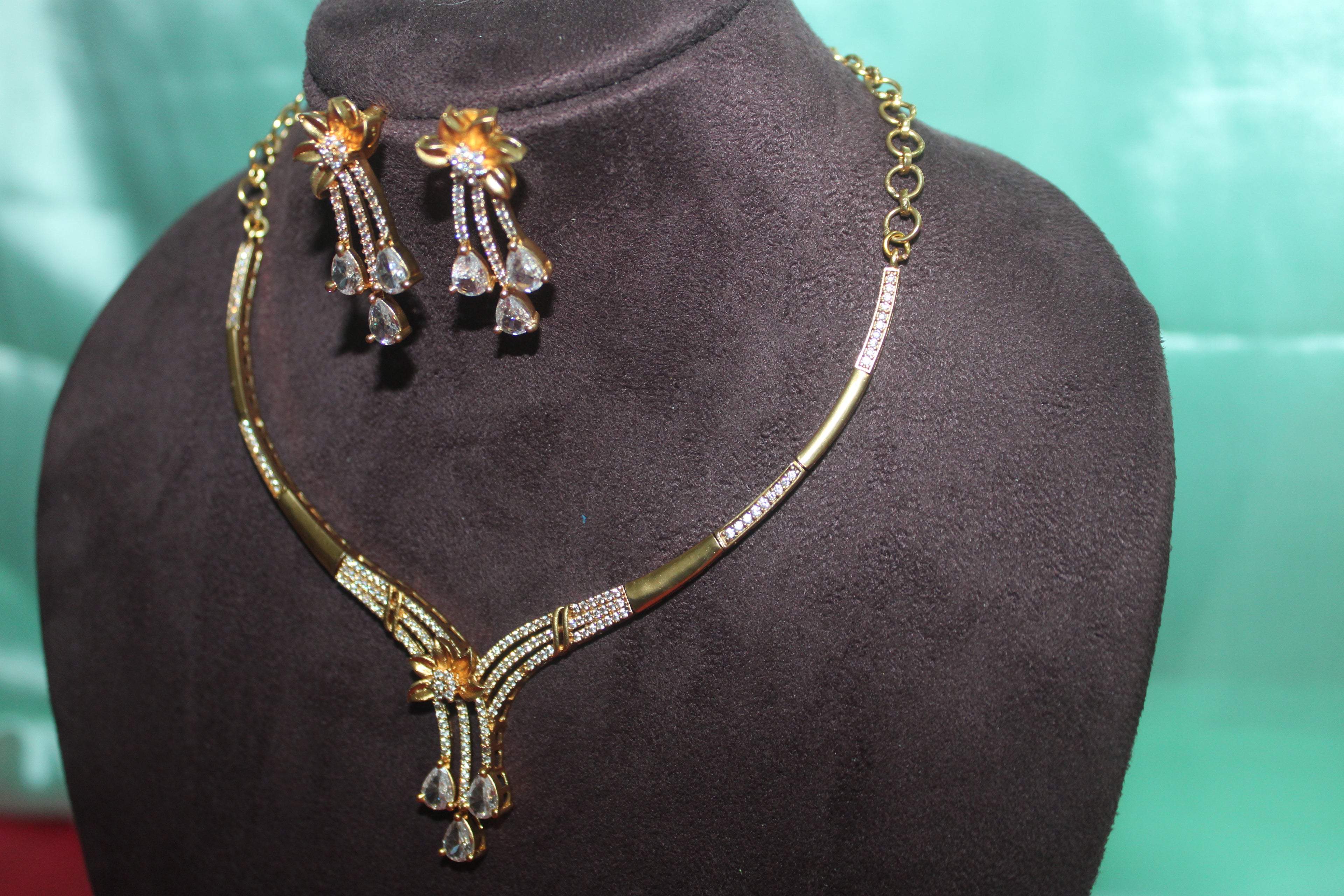 Modern necklace with american diamonds embedded in it u carve with earings