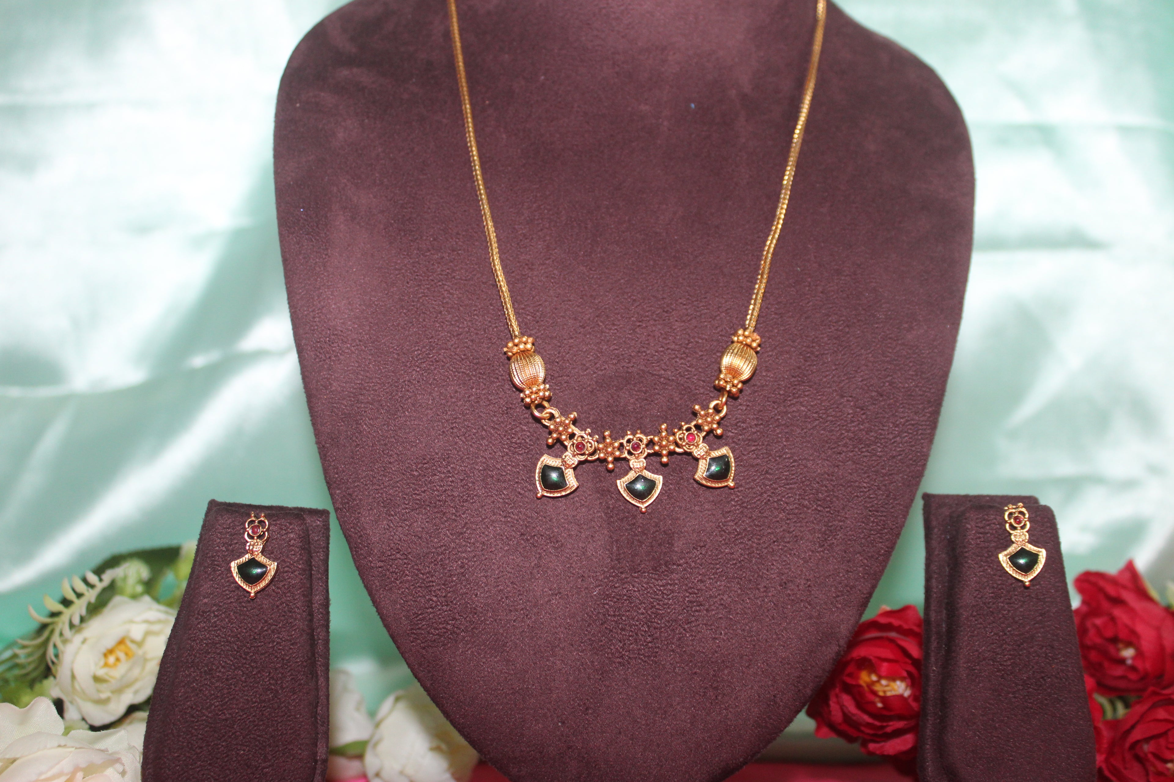 Simple neck chain with green stones and nakshi balls with earings