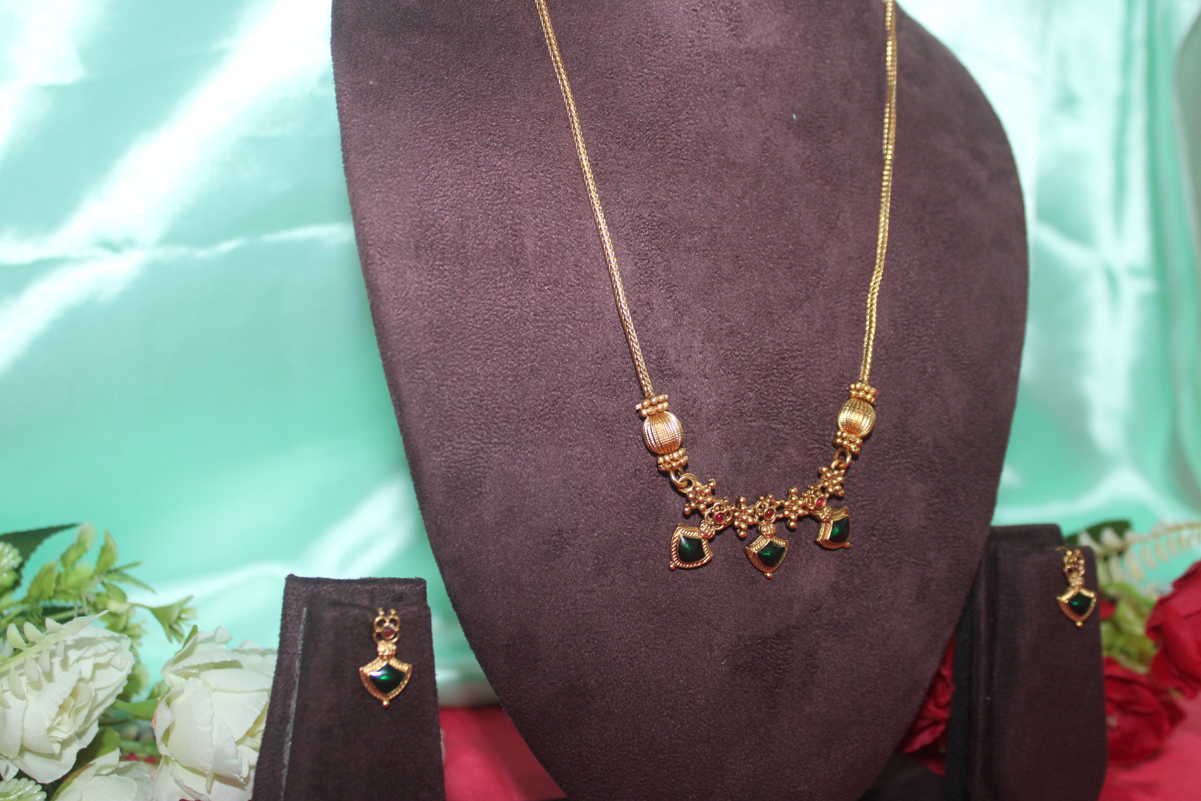 Simple neck chain with green stones and nakshi balls with earings