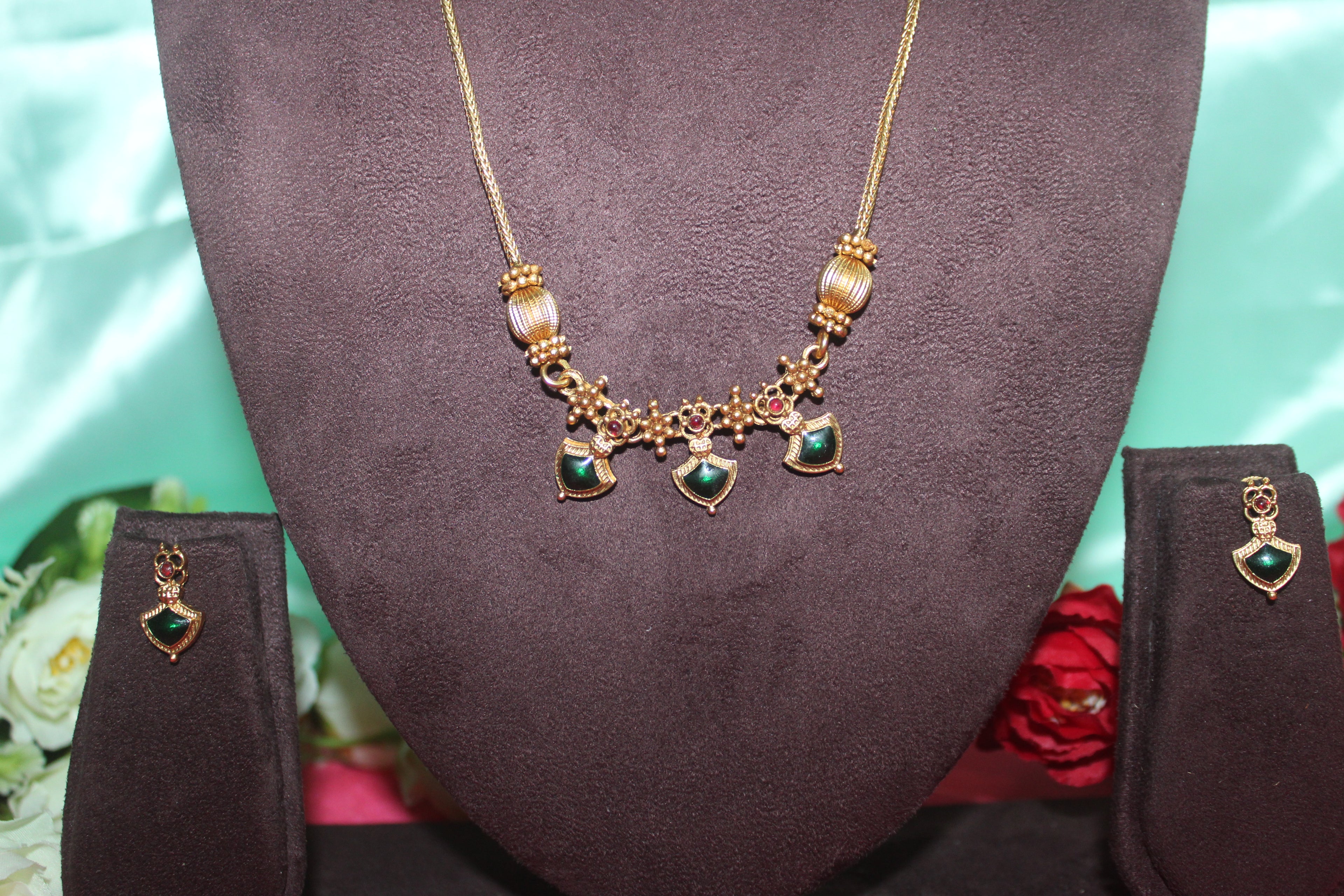 Simple neck chain with green stones and nakshi balls with earings