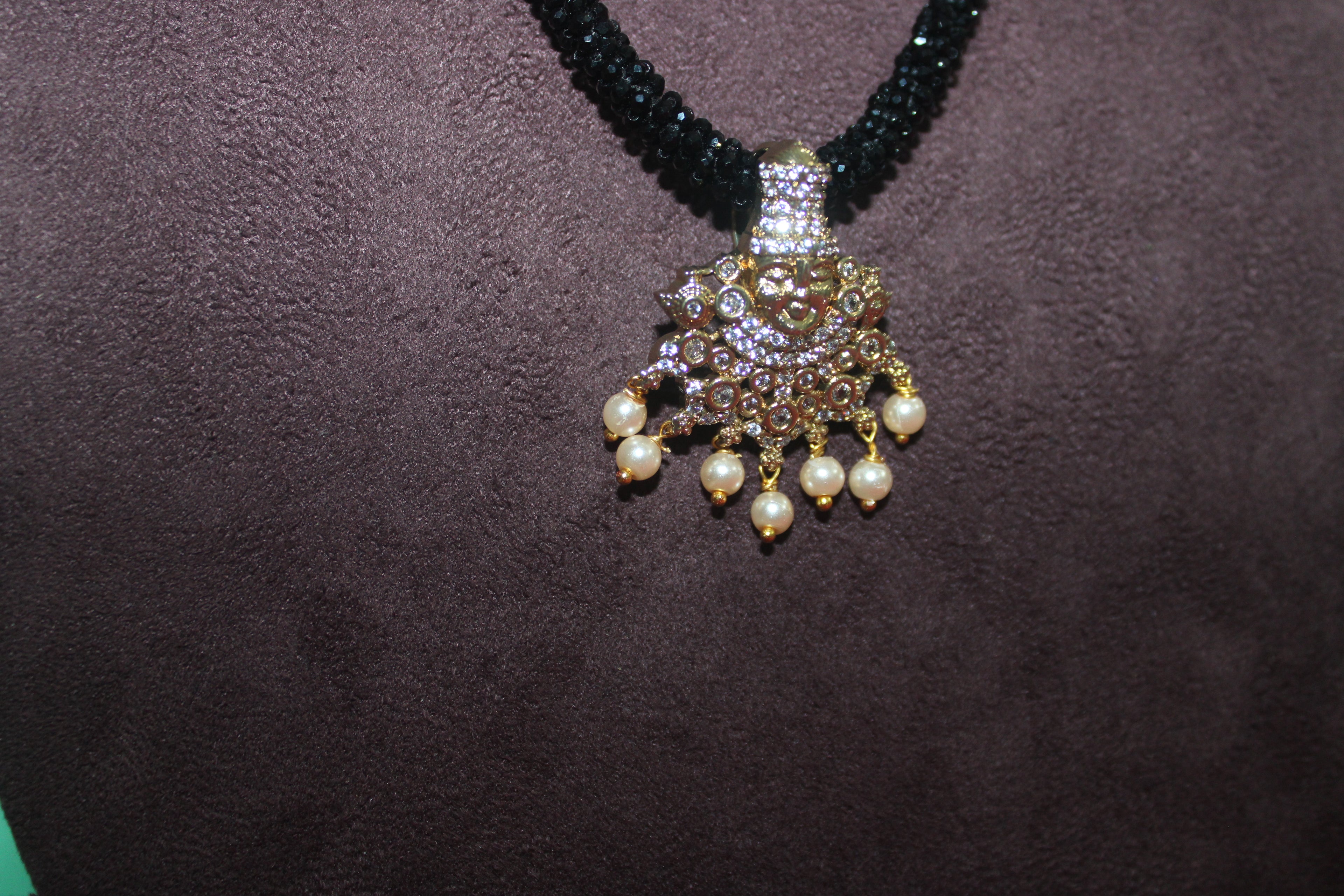 Black beads cz mala with lord venkateshwara diamonds embedded in it with matching earings
